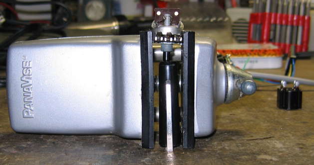 An object pushing in on the shaft will keep it in the proper position. Pot in vise, back up. Pen cap wedged between front end of pot shaft and workbench surface upon which vise head rests.