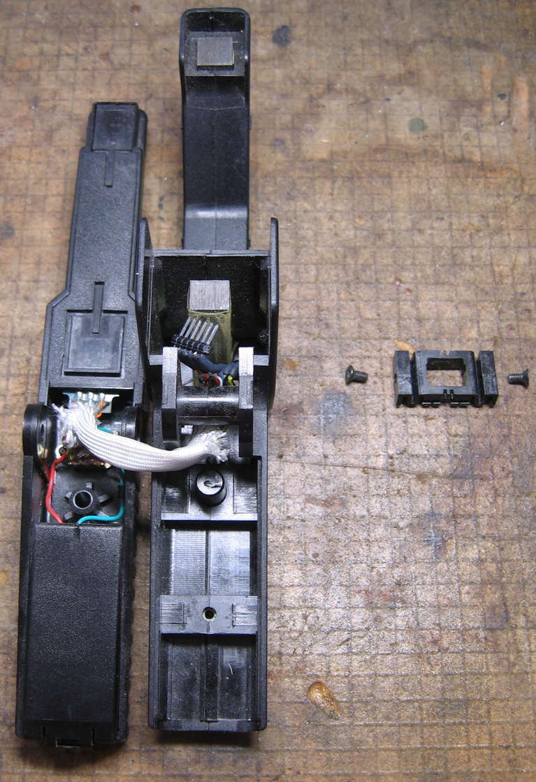 retainer removed, in original orientation to the right of the clamp halves