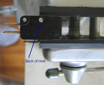 microswitch in vise, showing back of rivet ready to be drilled
