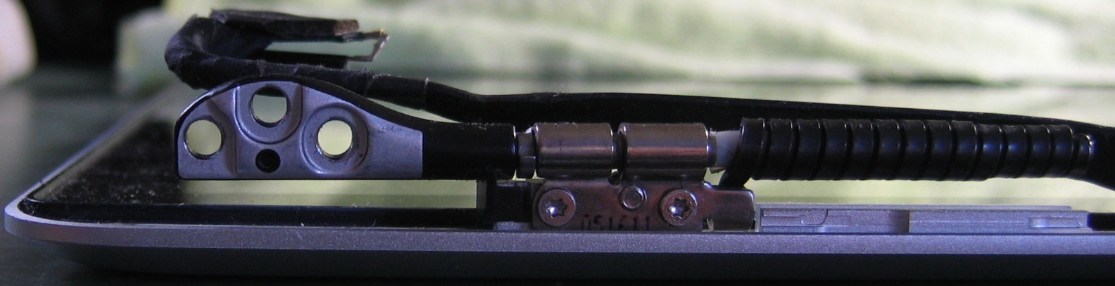 Close-up of left hinge/mounting bracket assembly, viewed from the bottom