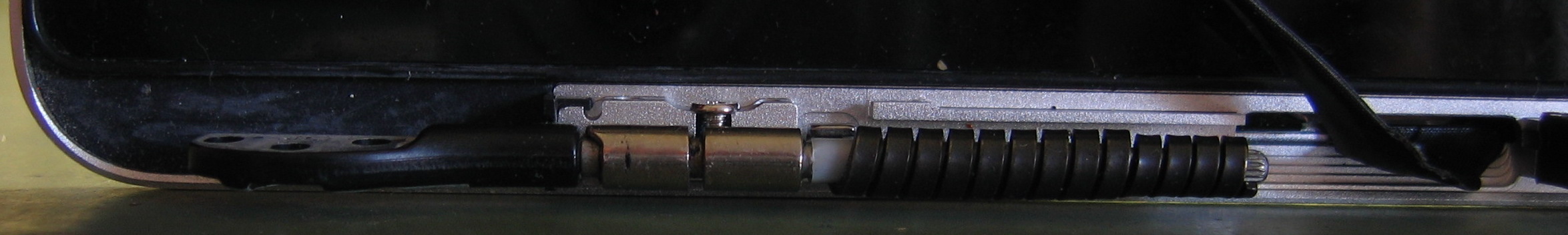 Close-up of left hinge/mounting bracket assembly, viewed from the side