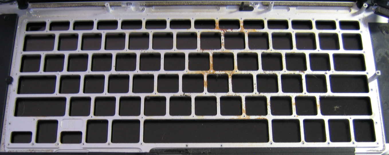 old liquid spill residue on back side of keyboard area of unibody top case aluminum
